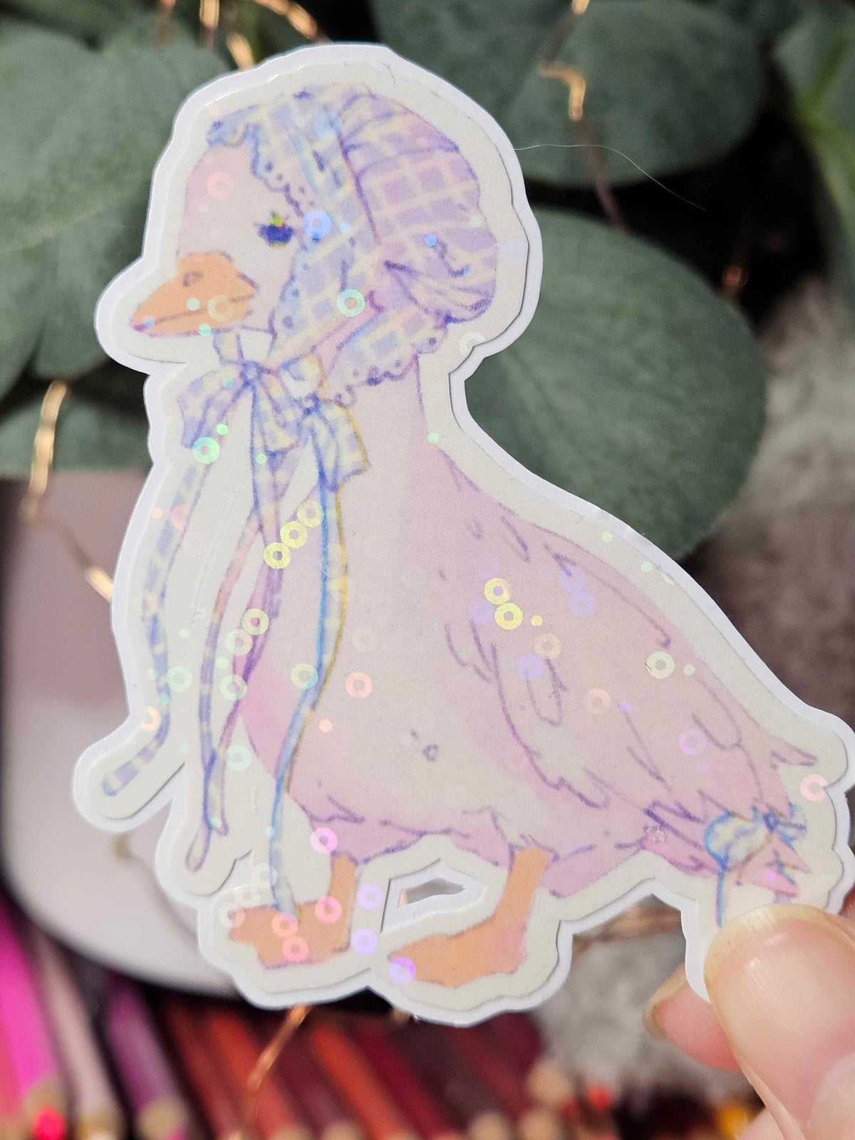 Close-up of Wander Goose sticker showing hand-drawn gingham pattern and ribbon detail