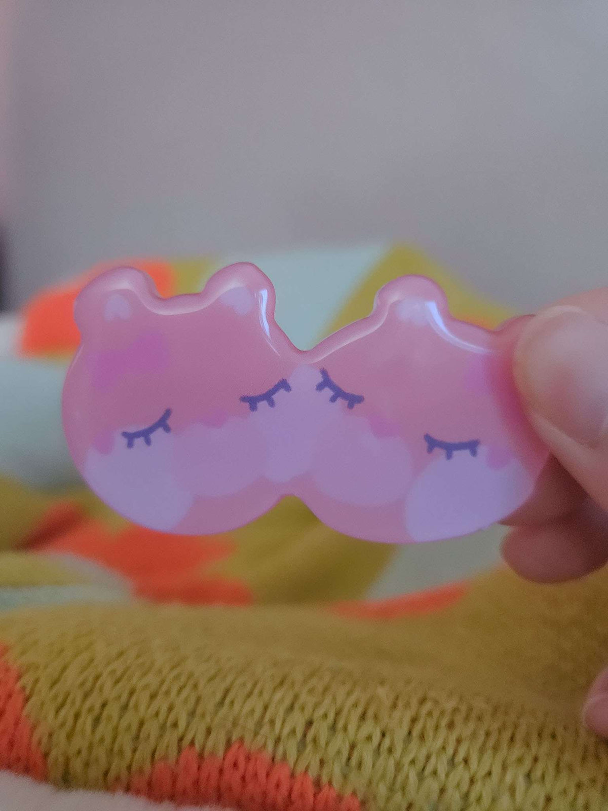Close-up of Wander Bear hairclip showing glossy resin coating and hand-illustrated bear face detail