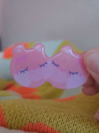 Close-up of Wander Bear hairclip showing glossy resin coating and hand-illustrated bear face detail