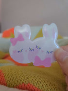 Close-up of Wander Rabbit hairclip showing glossy resin coating and hand-illustrated rabbit face detail