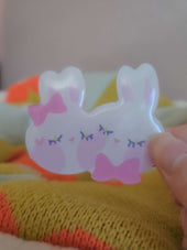 Close-up of Wander Rabbit hairclip showing glossy resin coating and hand-illustrated rabbit face detail