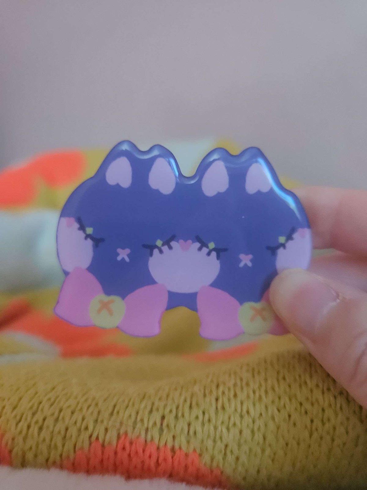 Close-up of Wander Cat hairclip showing glossy resin coating and hand-illustrated cat face detail