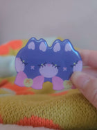 Close-up of Wander Cat hairclip showing glossy resin coating and hand-illustrated cat face detail