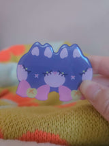 Close-up of Wander Cat hairclip showing glossy resin coating and hand-illustrated cat face detail