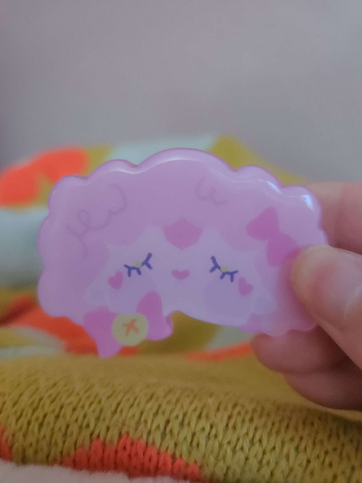 Close-up of Wander Sheep hairclip showing glossy resin coating and hand-illustrated sheep face detail
