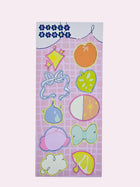 Silly Blobs pink variant sticker sheet featuring ten hand-drawn illustrated stickers including a diamond sparkle blob, peach blob, ribbon bow blob, green strawberry blob, fig blob, half circle blob, pink creature blob, teal bow blob, cloud blob, and lemon slice blob on a pink grid background by Ailyse of Finding Wonderland